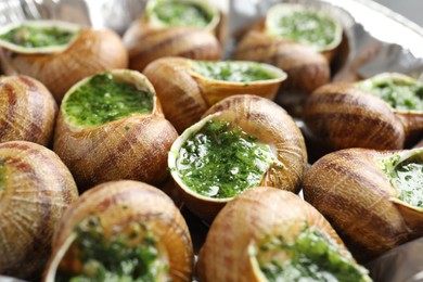 Delicious cooked snails on table, closeup view