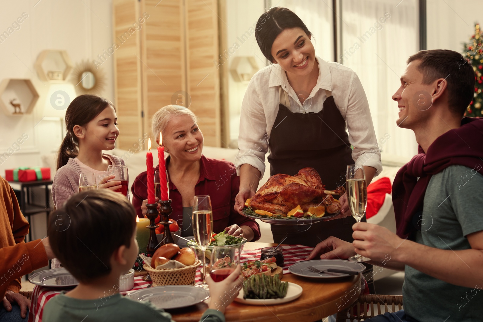 Photo of Happy family enjoying festive dinner at home. Christmas celebration