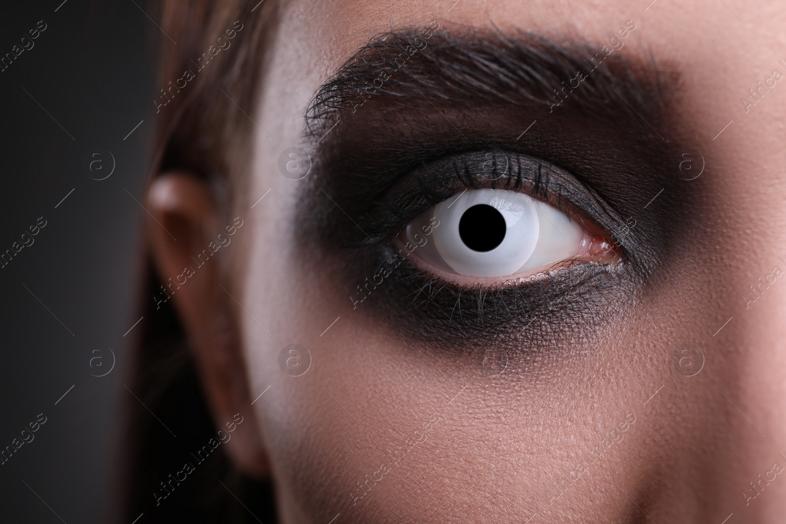 Photo of Mysterious witch with spooky eyes, closeup. Halloween party