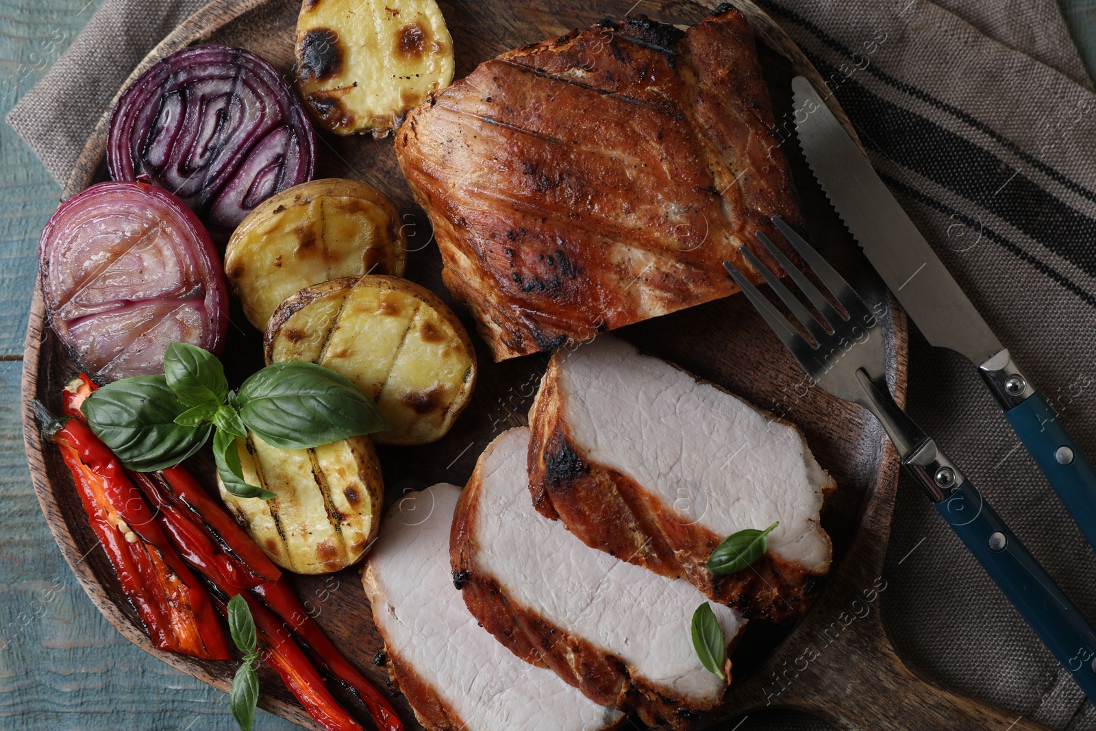 Delicious grilled meat and vegetables served on wooden table, top view Photo of Delicious grilled meat and vegetables served on wooden table, top view
