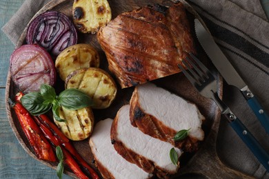 Photo of Delicious grilled meat and vegetables served on wooden table, top view