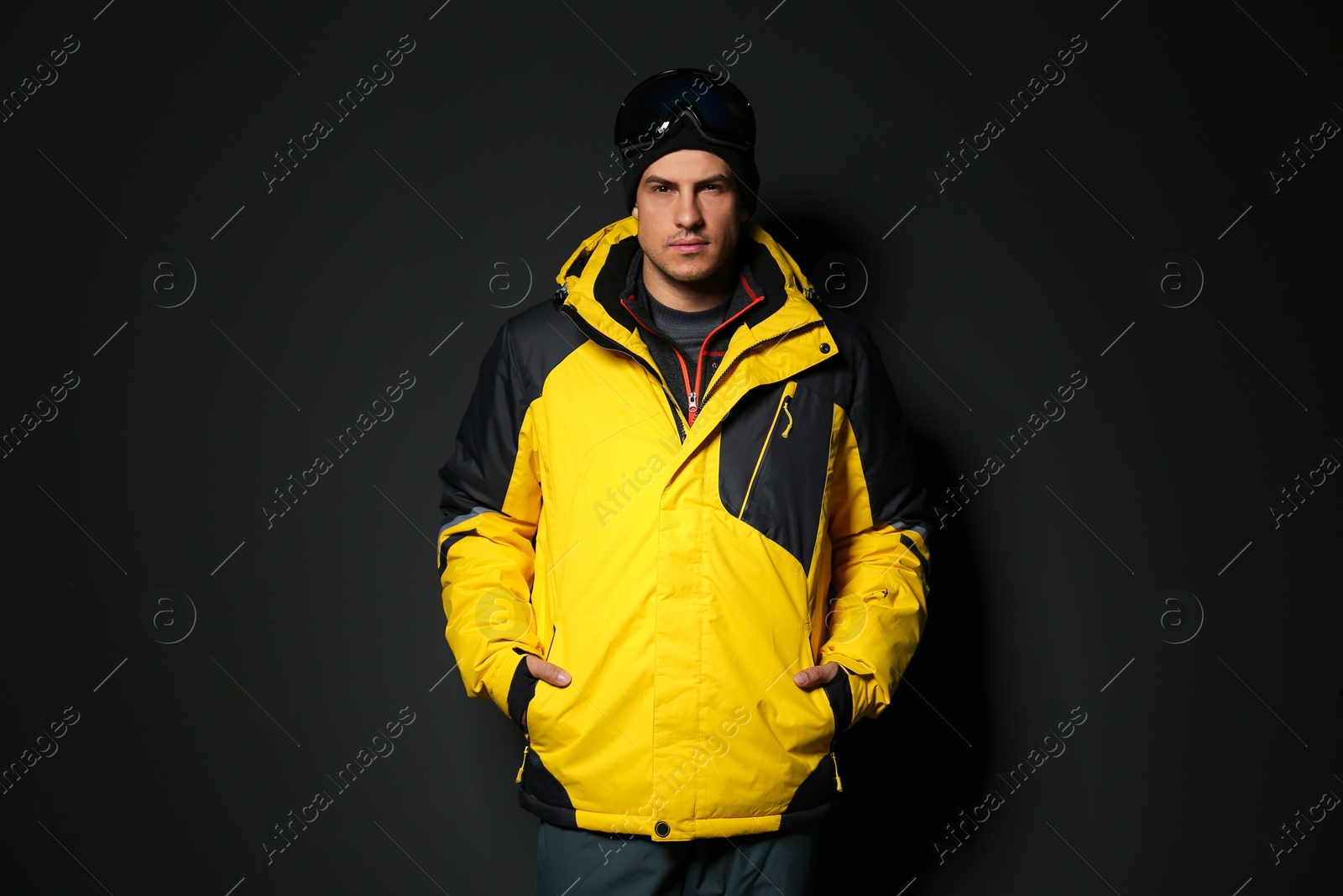 Photo of Man wearing stylish winter sport clothes on black background