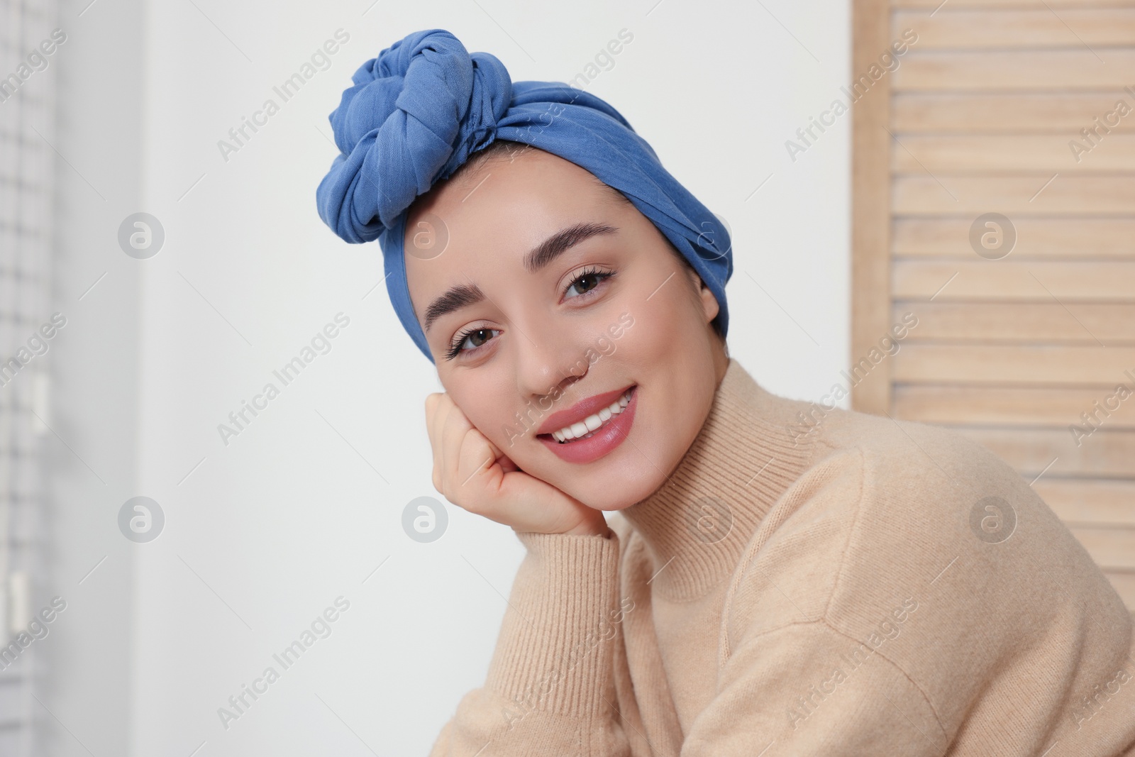 Photo of Cancer patient. Young woman with headscarf near window indoors