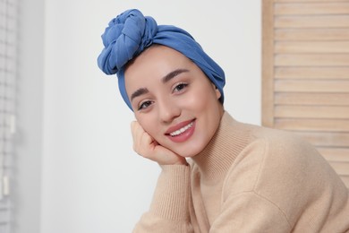 Photo of Cancer patient. Young woman with headscarf near window indoors