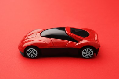 One bright car on red background. Children`s toy