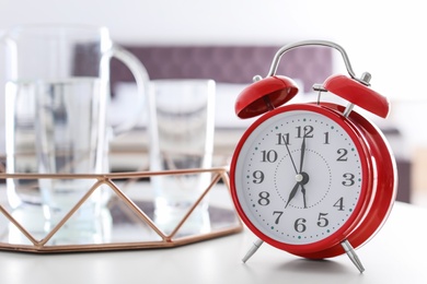 Alarm clock on table in bedroom. Time of day