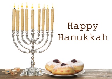 Image of Happy Hanukkah. Silver menorah, sufganiyot and dreidels on wooden table
