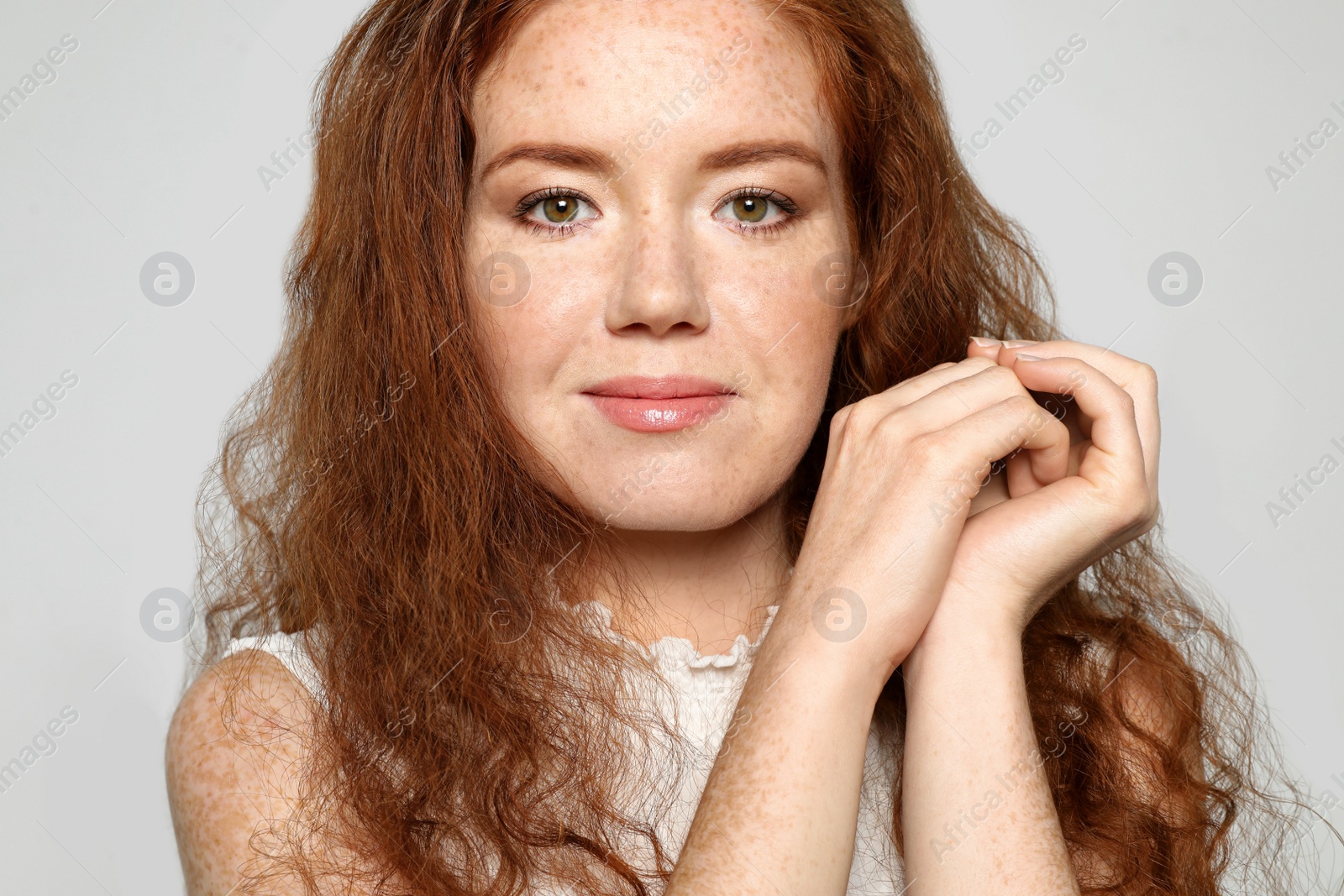 Photo of Portrait of young woman with beautiful face on grey background, closeup