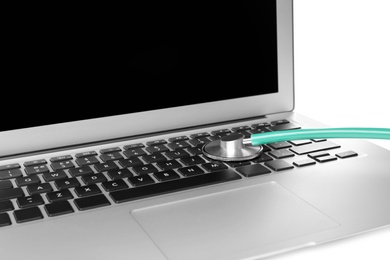 Photo of Laptop and stethoscope on white background, closeup. Computer repair