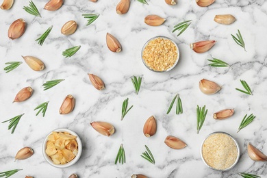 Flat lay composition with garlic products on marble background