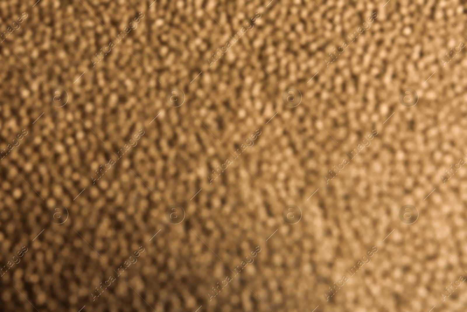 Photo of Blurred view of rough golden surface as background