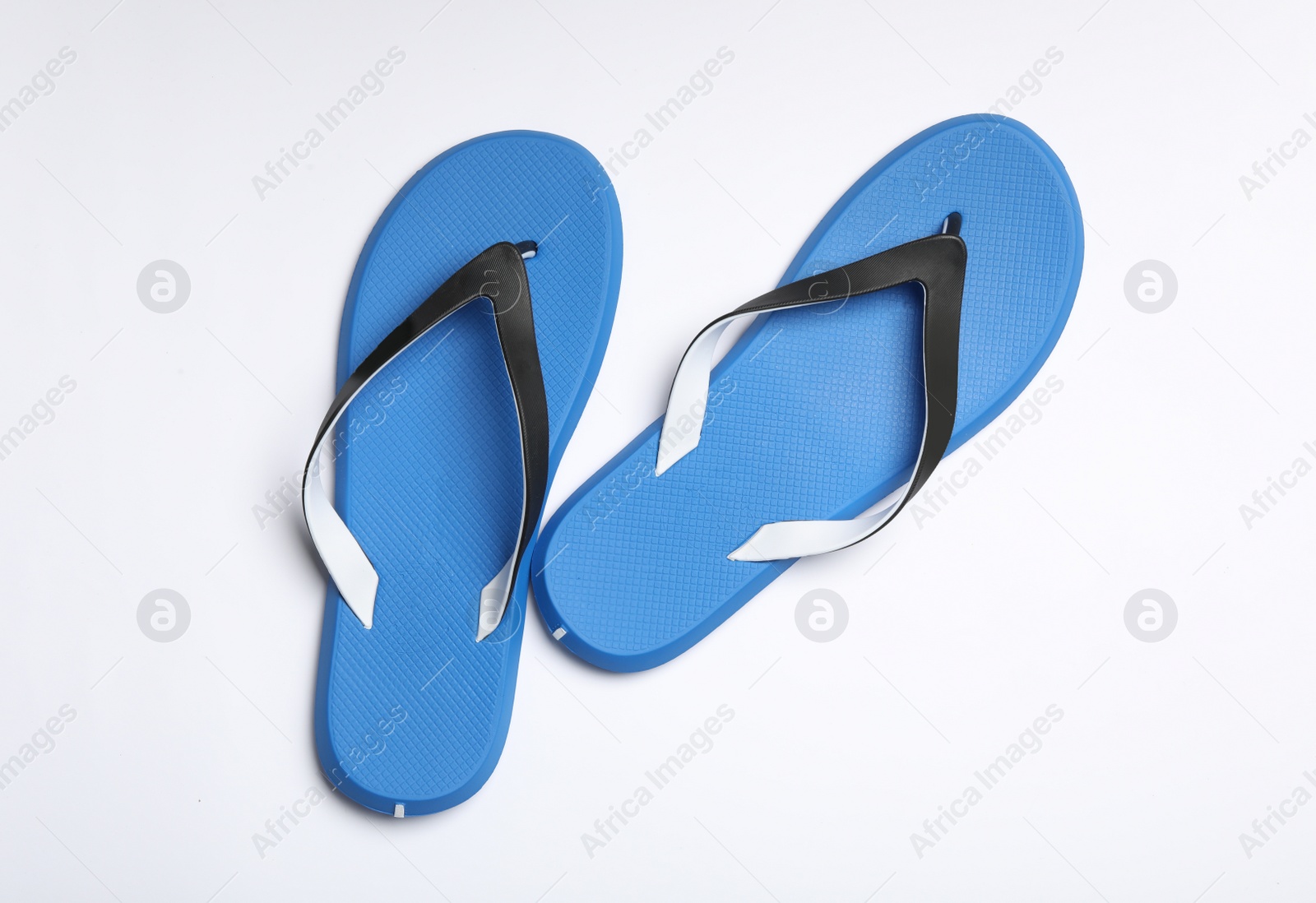 Photo of Pair of flip flops on white background, top view. Beach accessories