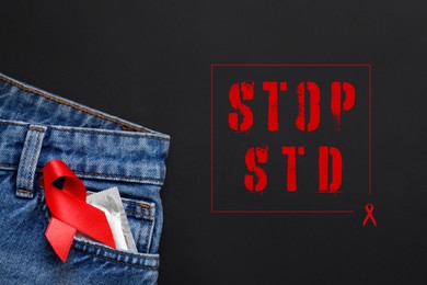 Image of Jeans with condom and red ribbon in pocket on black background, top view. STOP STD 