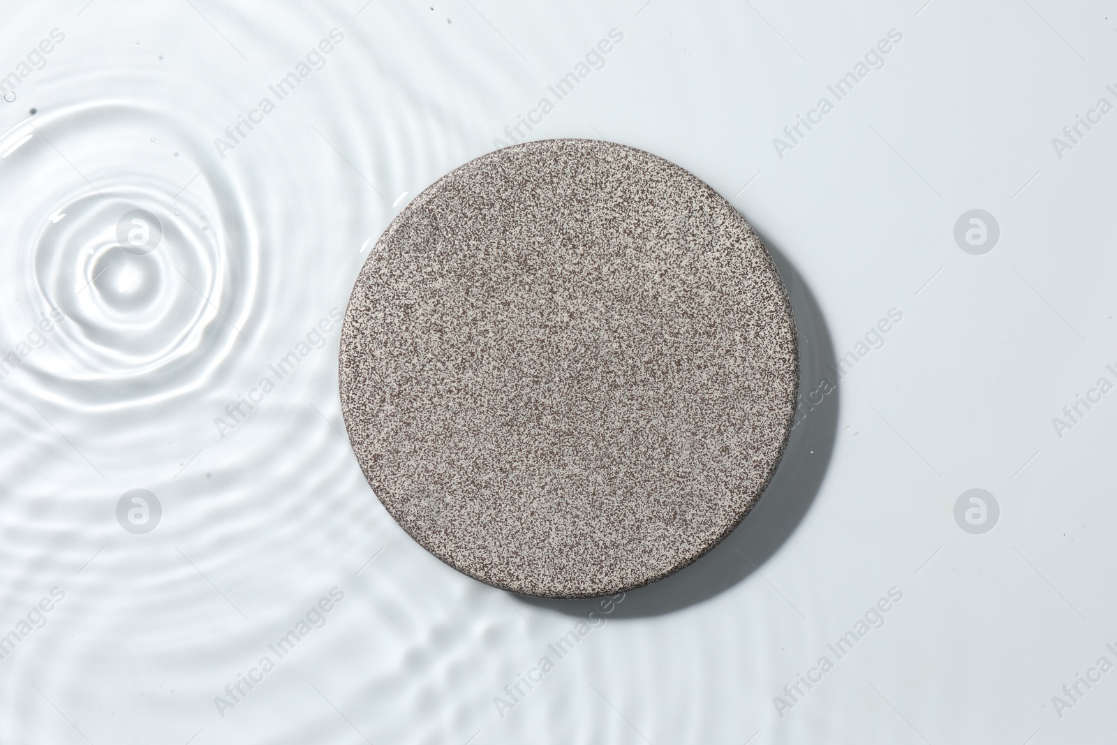 Photo of Presentation for product. Stone podium in water on white background, top view