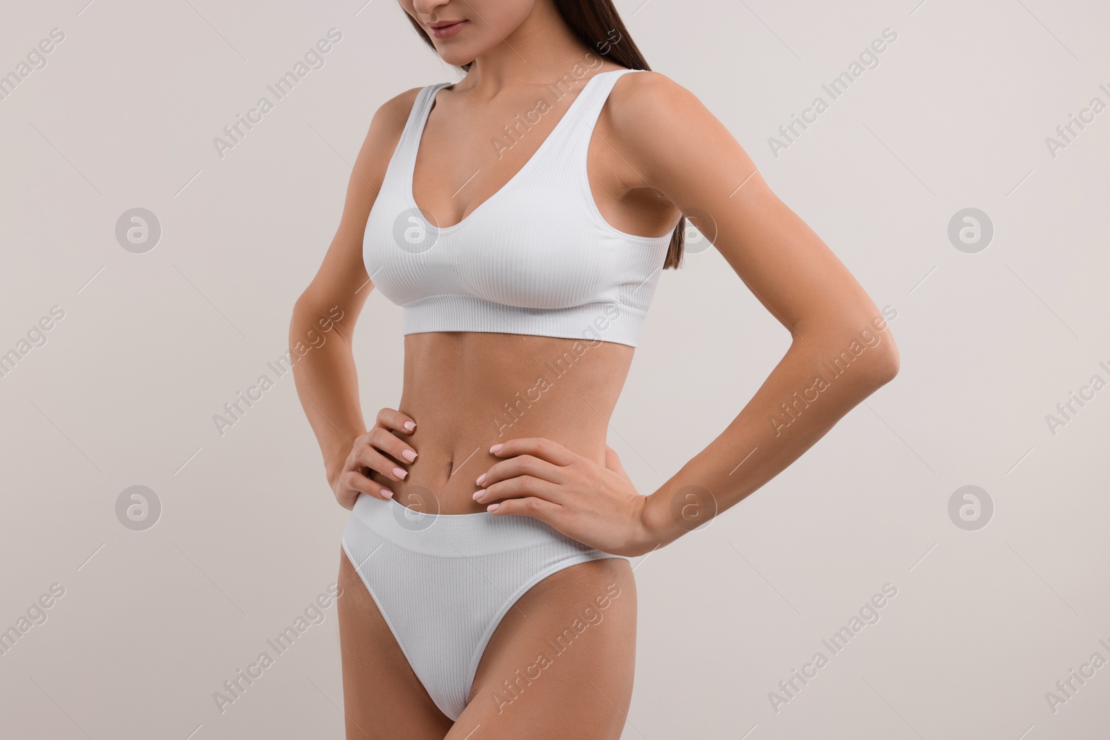 Photo of Young woman in stylish bikini on white background, closeup