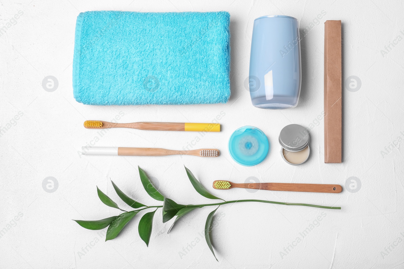 Photo of Flat lay composition with bamboo toothbrushes and toiletries on white background