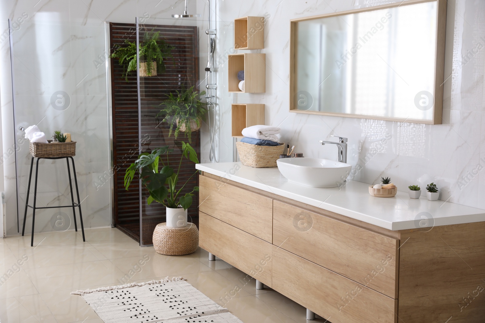 Photo of Bathroom interior with shower stall, counter and houseplants. Idea for design