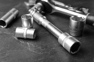 Auto mechanic's tools on grey background, closeup