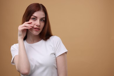 Photo of Portrait of beautiful woman on beige background. Space for text