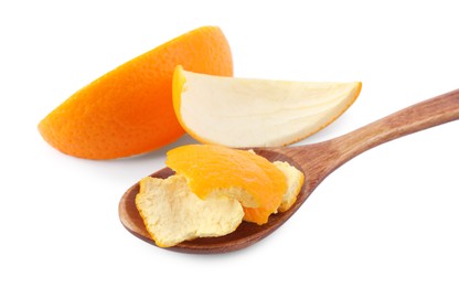 Photo of Orange peels preparing for drying and spoon isolated on white