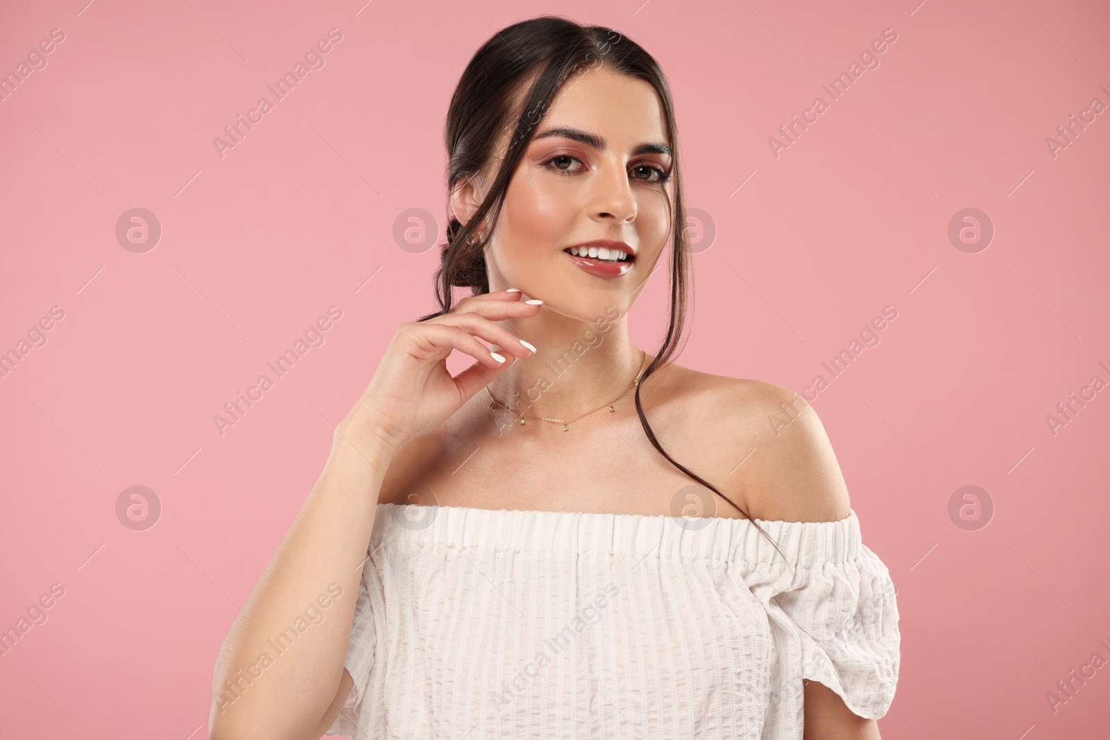 Photo of Beautiful woman with elegant jewelry on pink background