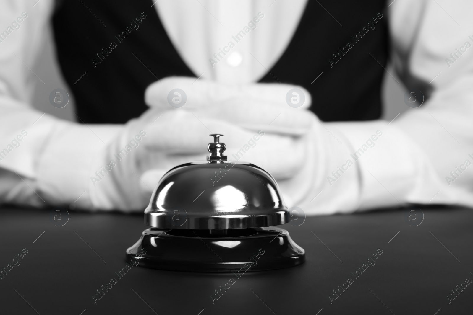 Photo of Butler at desk with service bell, closeup view