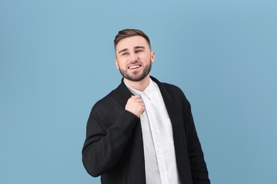 Photo of Portrait of confident young man on color background