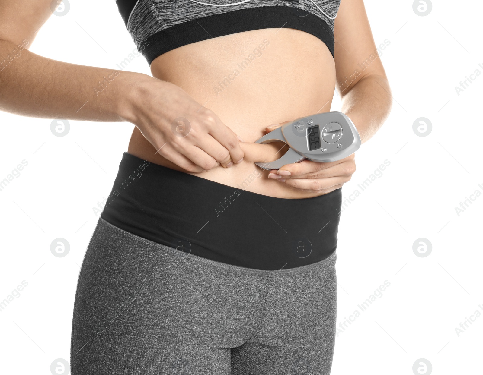 Photo of Young woman measuring body fat with caliper on white background, closeup