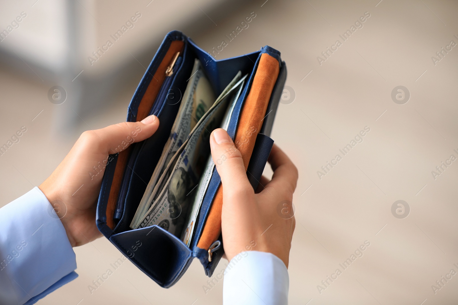 Photo of Woman with American money in wallet indoors, closeup