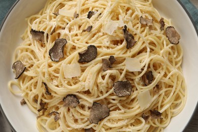 Tasty spaghetti with truffle in dish, closeup. Top view