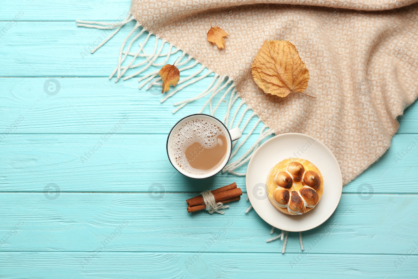 Photo of Flat lay composition with coffee and warm plaid on turquoise wooden table, space for text