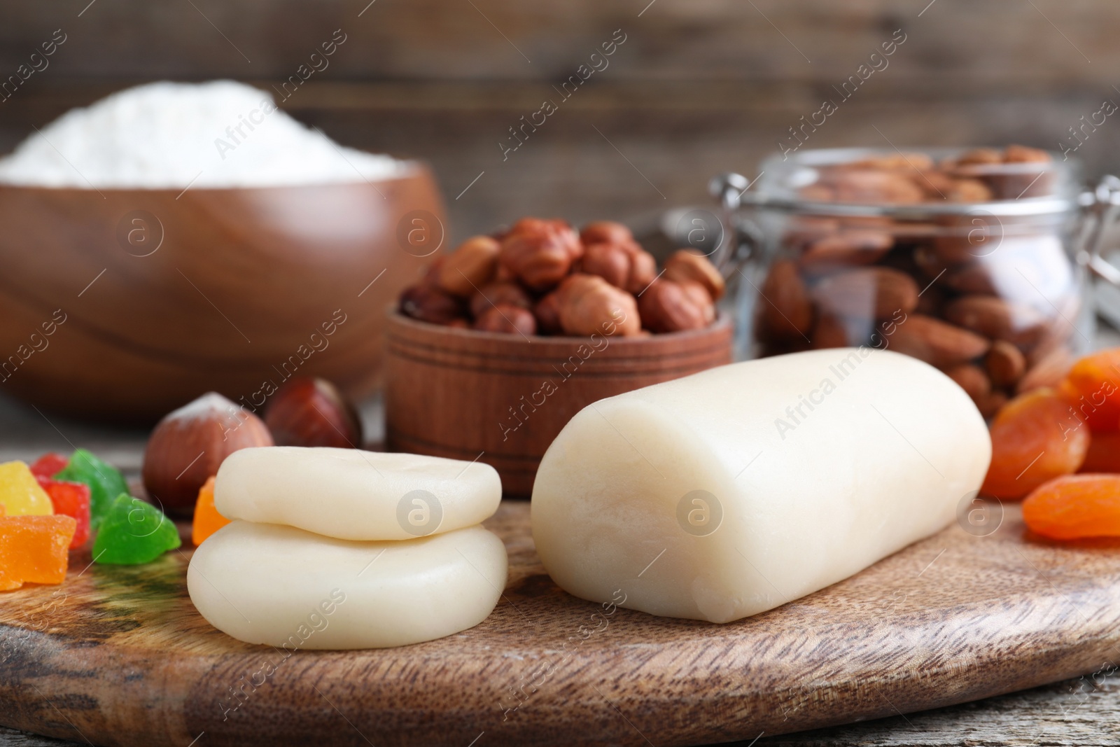 Photo of Marzipan and other ingredients for homemade Stollen on wooden table, closeup. Baking traditional German Christmas bread