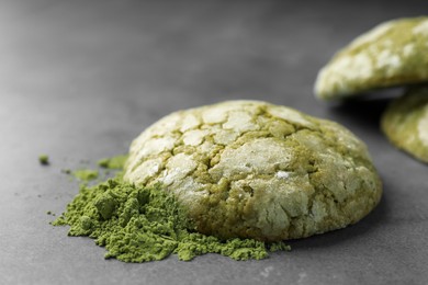 Photo of Tasty matcha cookie and powder on grey table, closeup
