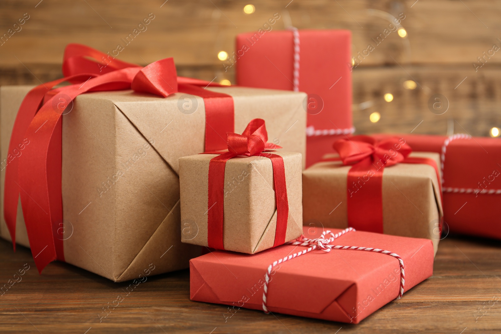 Photo of Many Christmas gifts on wooden table. Boxing day