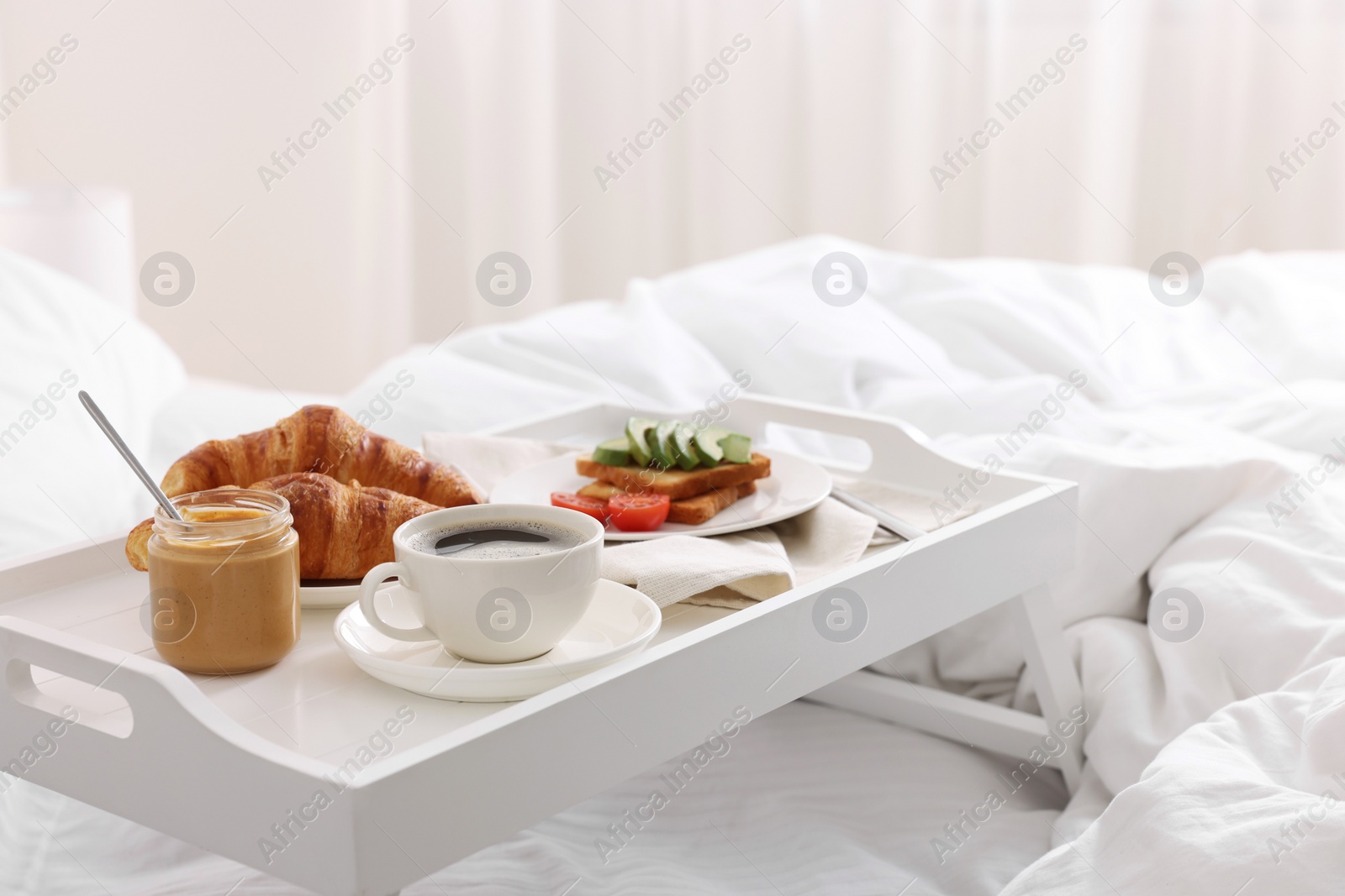 Good morning. Tray with tasty breakfast on bed at home Photo of Good morning. Tray with tasty breakfast on bed at home