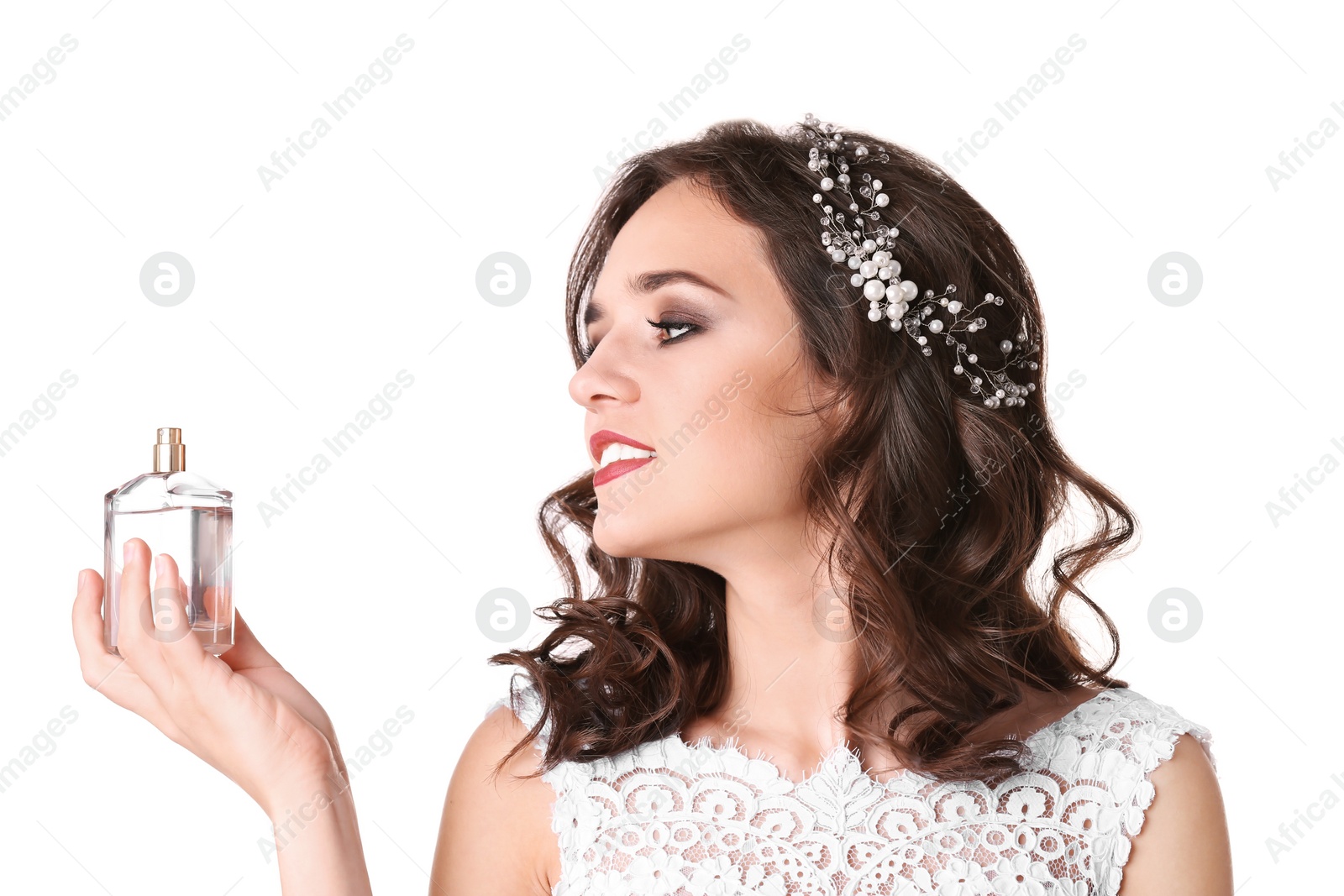 Photo of Beautiful young bride with bottle of perfume on white background