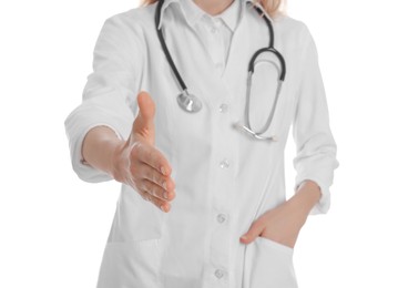 Female doctor offering handshake on white background, closeup