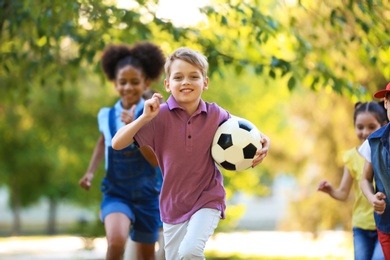 Photo of Cute little children playing with ball outdoors on sunny day