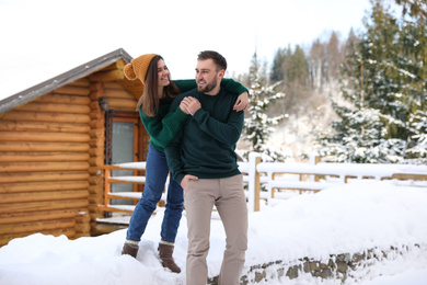 Lovely couple walking together on snowy day. Winter vacation