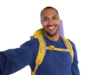 Photo of Happy tourist with backpack taking selfie on white background