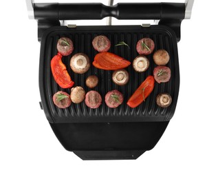 Electric grill with meat balls, bell pepper and mushrooms isolated on white, top view