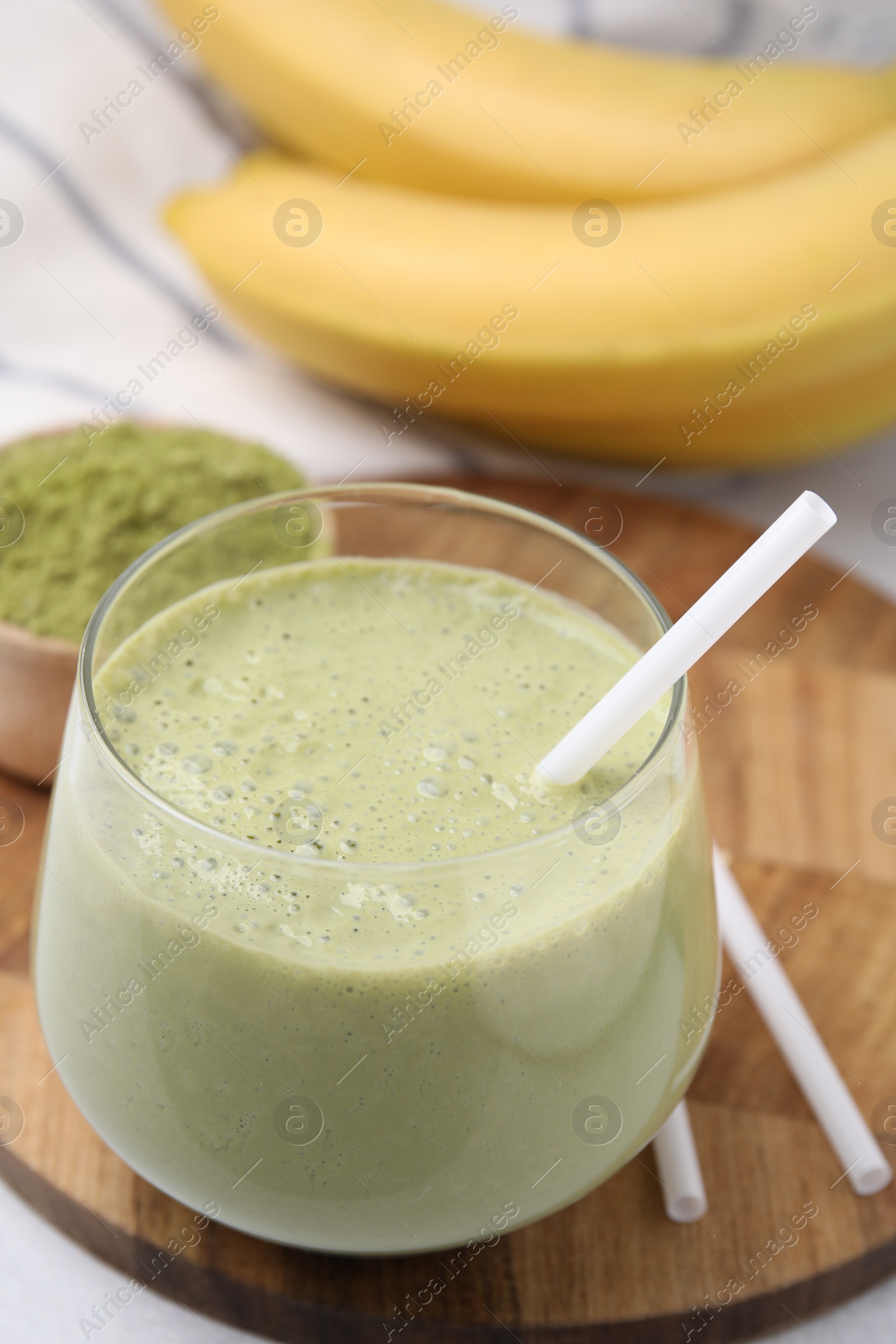 Photo of Glass of tasty matcha smoothie on table, closeup