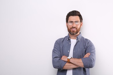 Portrait of handsome man in glasses on white background, space for text