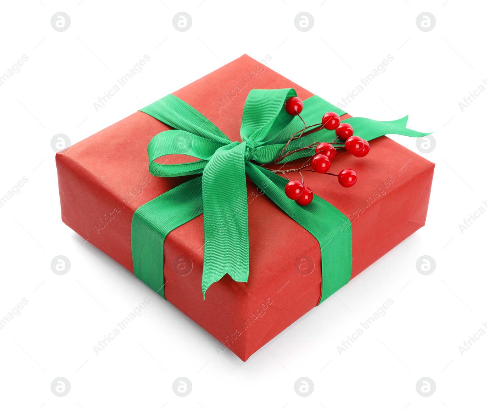 Photo of Christmas gift box decorated with green bow and berries isolated on white