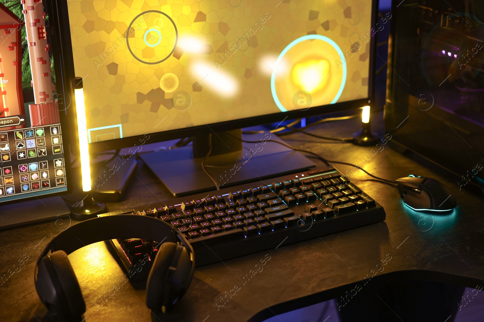 Photo of Playing video games. Computer monitor, keyboard, mouse and headphones on table indoors