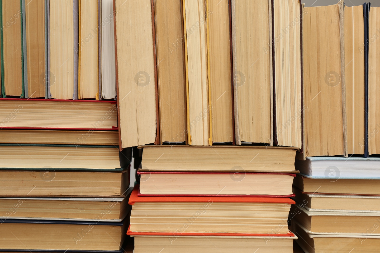 Photo of Many hardcover books as background. Library material