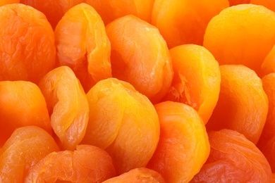 Photo of Tasty apricots as background, closeup. Dried fruit as healthy food