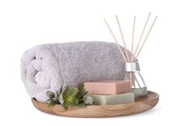 Photo of Tray with towel, air freshener and soap bars isolated on white. Spa treatment