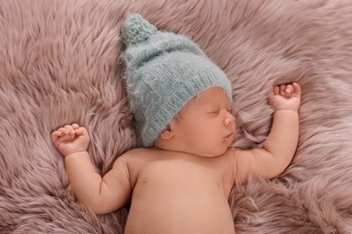 Cute newborn baby sleeping on fluffy blanket, top view