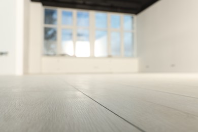 Photo of Empty room with new white laminated flooring, closeup